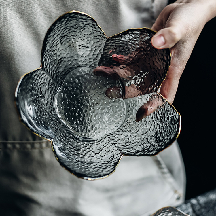 A gray salad bowl with a gold rim and petal-shaped design  42